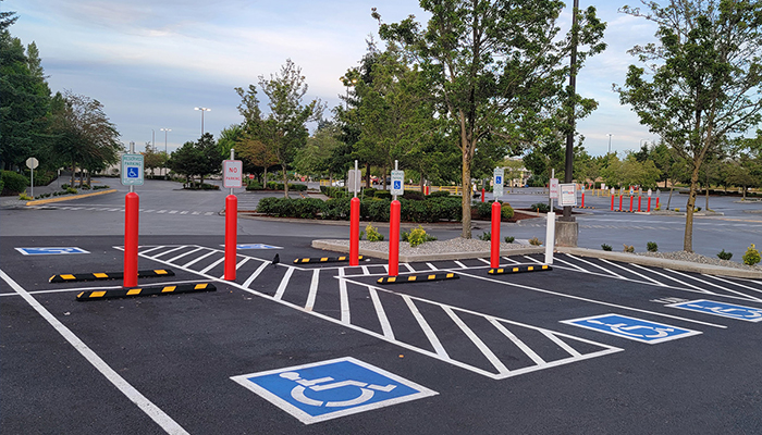 Handicap-accessible parking area with marked spaces and signs.