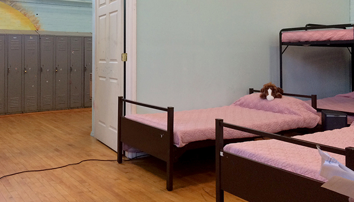 Bedroom with multiple beds with pink sheets
