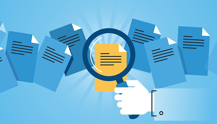 Illustration of documents being reviewed with a magnifying glass.